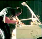 Photograph of police officer searching a car trunk