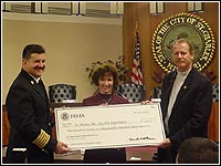 Photo of Director Hainje, Mayor York and Chief Rhodes holding a check.