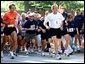 President George W. Bush competes in the 3 mile run as part of The President's Fitness Challenge at Ft. McNair on Saturday June 21, 2002. White House photo by Paul Morse.