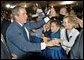 President George W. Bush greets audience members after speaking during the Colorado Welcome at the Wings Over The Rockies Air and Space Museum in Denver, Colo., Monday, Oct. 28. White House photo by Eric Draper.
