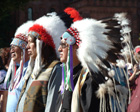 American Indian men dressed in festive costumes