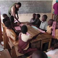 A teacher assisting pupils