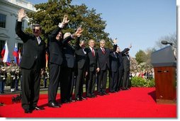 President George W. Bush waves with Prime Ministers of seven countries after a South Lawn ceremony welcoming them into NATO Monday, March 29, 2004. From left are: Prime Minister Indulis Emsis of Latvia, Prime Minister Anton Rop of Slovenia, Prime Minister Algirdas Brazauskas of Lithuania, Prime Minister Mikulas Dzurinda of the Slovak Republic, President George W. Bush, Prime Minister Adrian Nastase of Romania, Prime Minister Simeon Saxe-Coburg Gotha of Bulgaria, Prime Minister Juhan Parts of Estonia, and NATO Secretary General Jaap de Hoop Scheffer. White House photo by Susan Sterner.