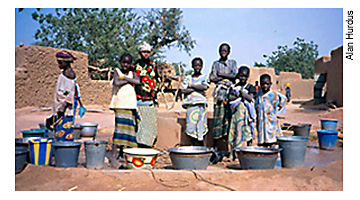 Children in Mali gather water from community well