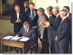 President George W. Bush signs the Chile and Singapore Free Trade Agreement Implementation Acts in the East Room Wednesday, Sept. 3, 2003. White House photo by Tina Hager.