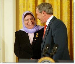 President George W. Bush greets Dr. Raja Habib Khuzai of the Iraqi Governing Council after delivering remarks on Women’s Human Rights in the East Room of the White House Fridy, March 12, 2004. White House photo by Paul Morse.