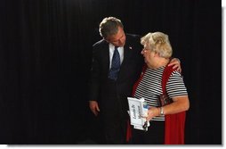 President George W. Bush embraces Loretta De Maintenon after meeting with seniors about his commitment to add prescription drug benefits to Medicare during a visit to Orlando, Fla., Thursday, Nov. 13, 2003. White House photo by Tina Hager.