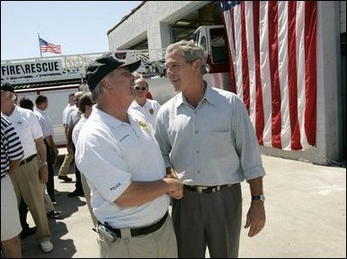 President George W. Bush greets Arthur Bourne, Police Chief of Gulf Shores, during a visit with First Responders at the Orange Beach Fire and Rescue Station 1 in Orange Beach, Alabama Sunday, Sept. 19, 2004. White House photo by Eric Draper.